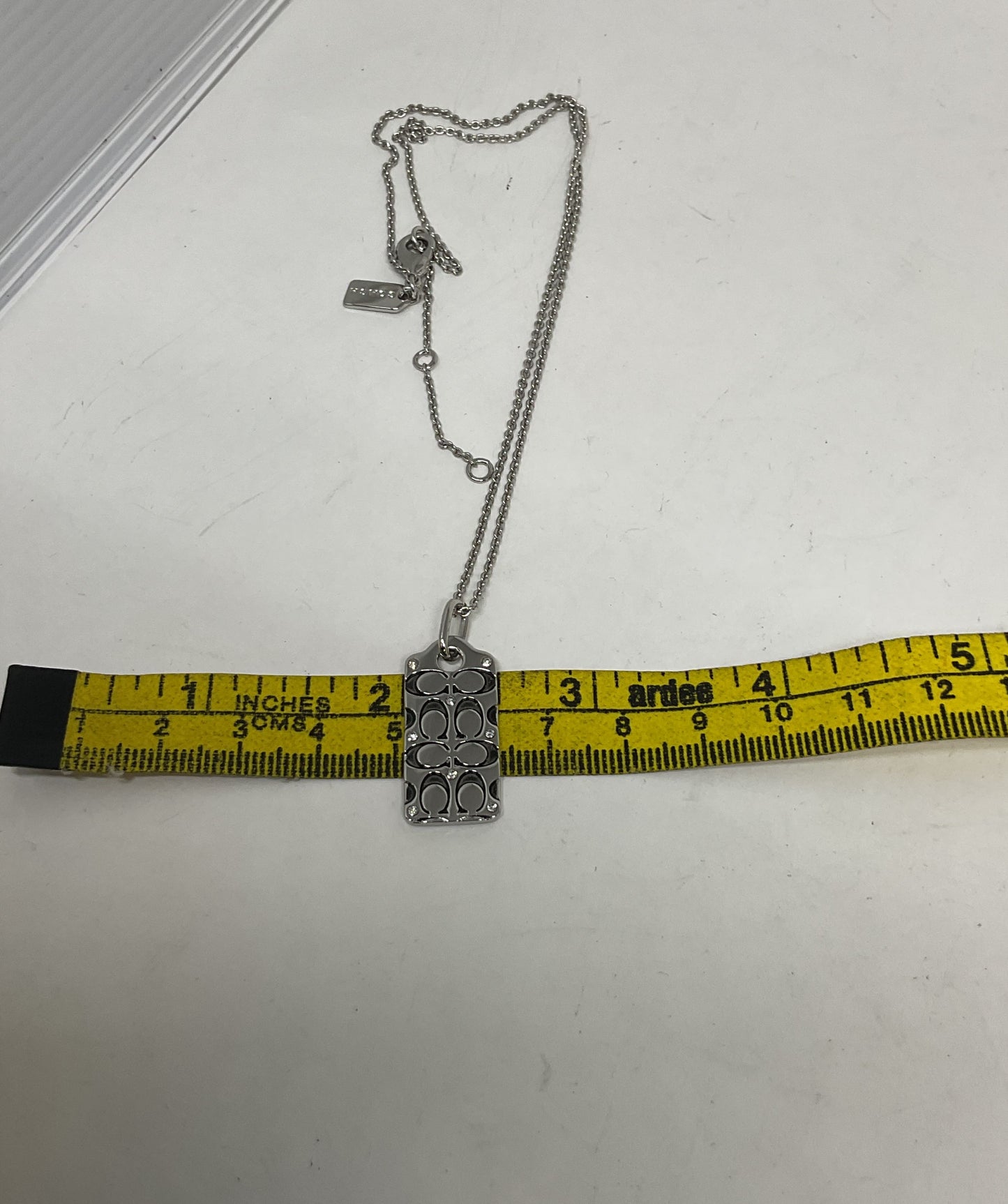 Coach Silver Tone Logo Pendant Necklace